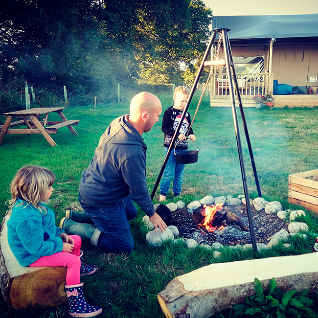 A family feast cooked over Willow safari tent's BBQ